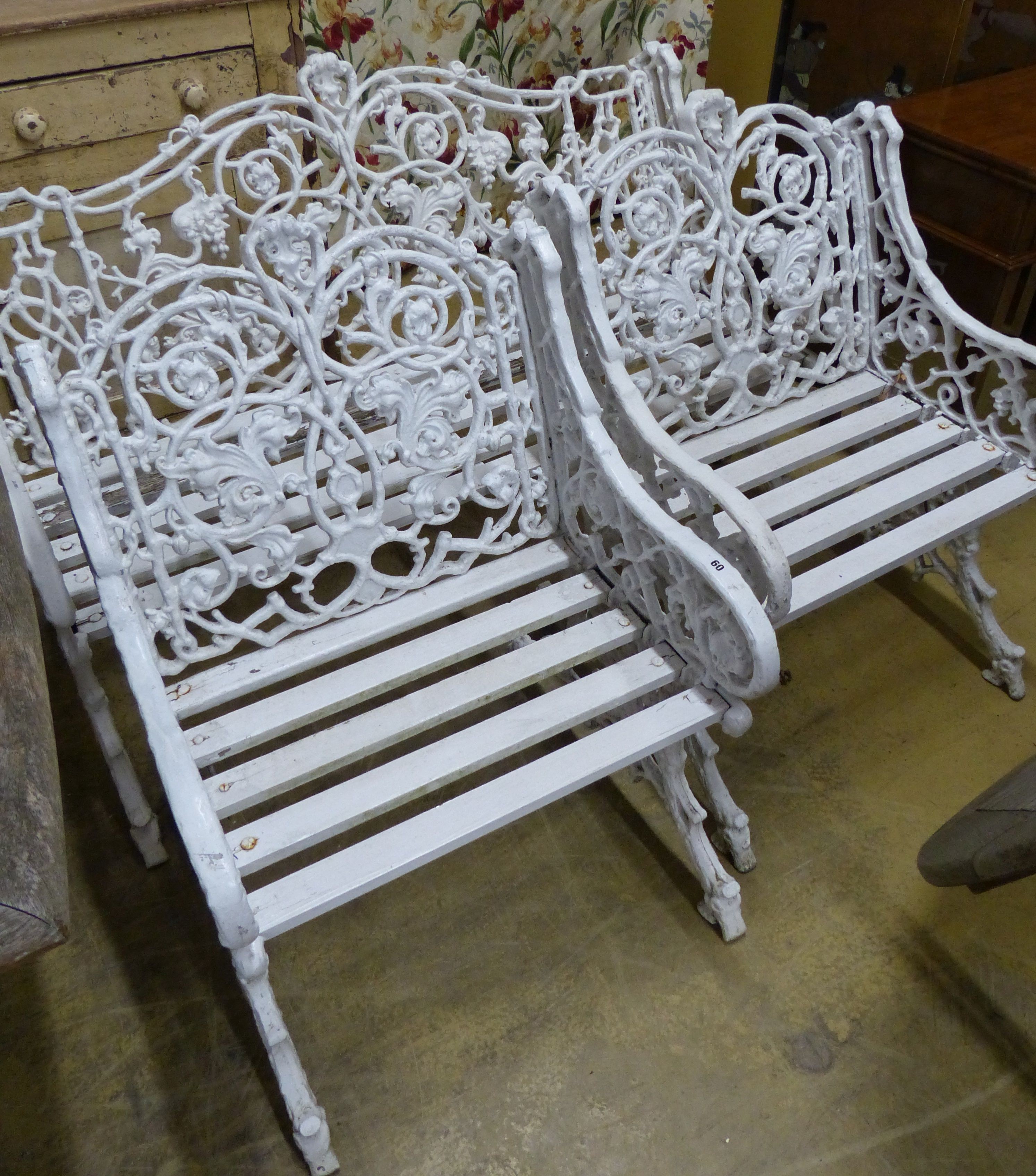 A Victorian style Coalbrookdale design painted metal garden bench and two armchairs, bench W.126cm D.60cm H.90cm